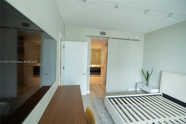 45 SW 9th St Unit 1705, Miami, FL 33130 - unfurnished bedroom featuring wood finished floors and a barn door