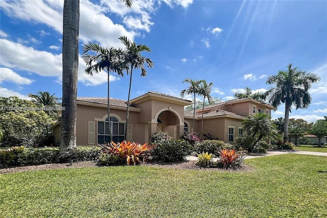 3230 SW 139th Ter, Davie, FL 33330 - mediterranean / spanish-style house featuring a front yard, stucco siding, and a tiled roof