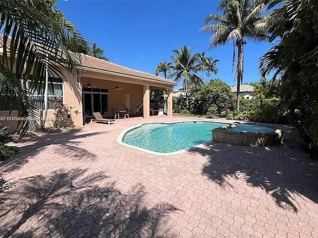 3230 SW 139th Ter, Davie, FL 33330 - view of swimming pool featuring ceiling fan, a patio area, and a pool with connected hot tub