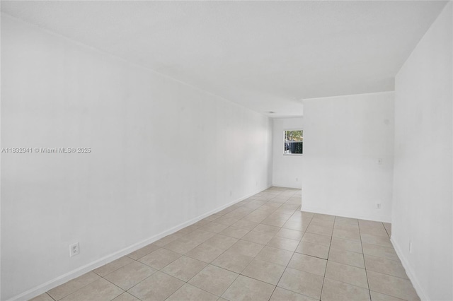 1200 W 31st St, Riviera Beach, FL 33404 - spare room featuring light tile patterned floors and baseboards