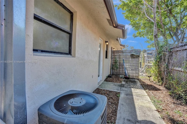 1200 W 31st St, Riviera Beach, FL 33404 - view of side of property with a central air condition unit and stucco siding