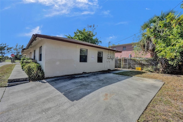 1200 W 31st St, Riviera Beach, FL 33404 - back of property featuring stucco siding and a patio area