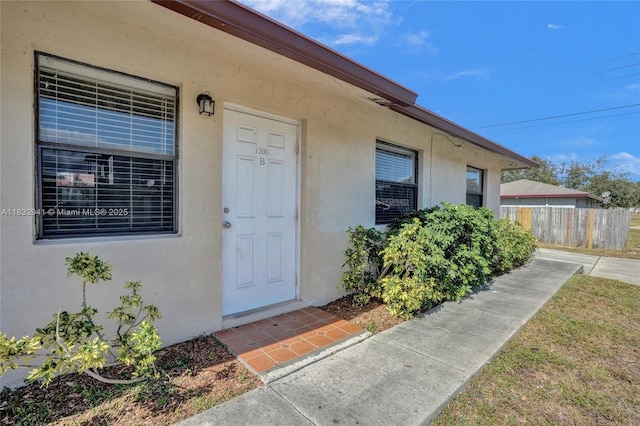 1200 W 31st St, Riviera Beach, FL 33404 - doorway to property featuring stucco siding