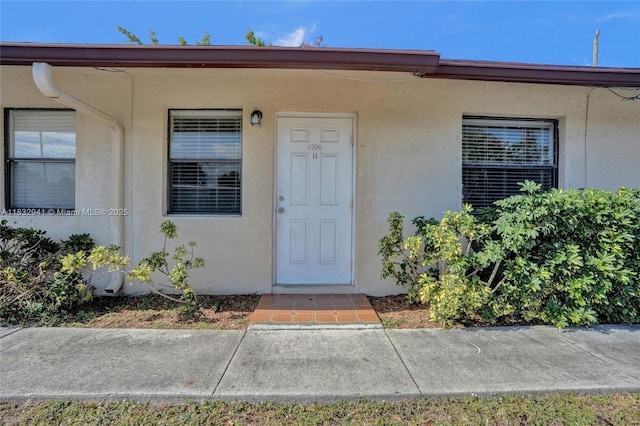 1200 W 31st St, Riviera Beach, FL 33404 - property entrance featuring stucco siding