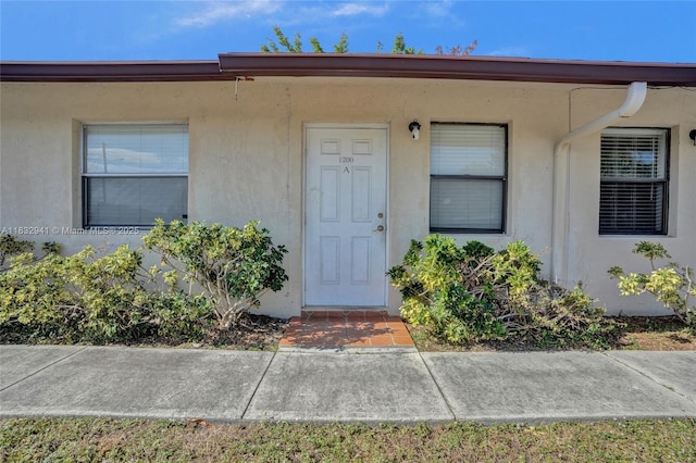 1200 W 31st St, Riviera Beach, FL 33404 - property entrance featuring stucco siding