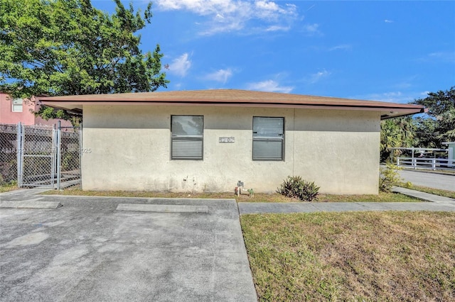 1200 W 31st St, Riviera Beach, FL 33404 - view of front facade with stucco siding and a patio