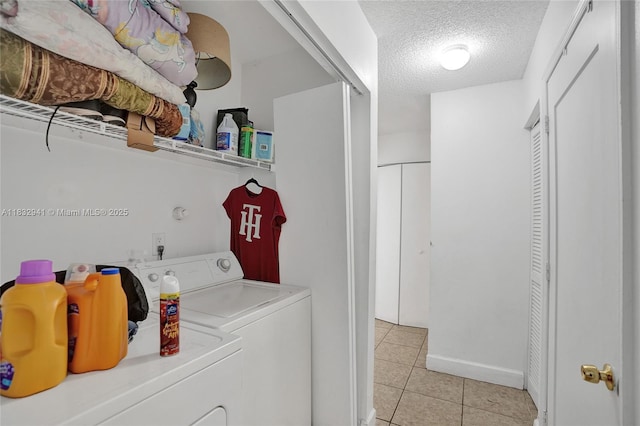 1200 W 31st St, Riviera Beach, FL 33404 - washroom with washer and clothes dryer, light tile patterned floors, and a textured ceiling