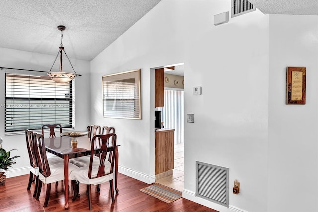 631 SW 113th Ave, Pembroke Pines, FL 33025 - dining area featuring a textured ceiling, wood finished floors, and vaulted ceiling