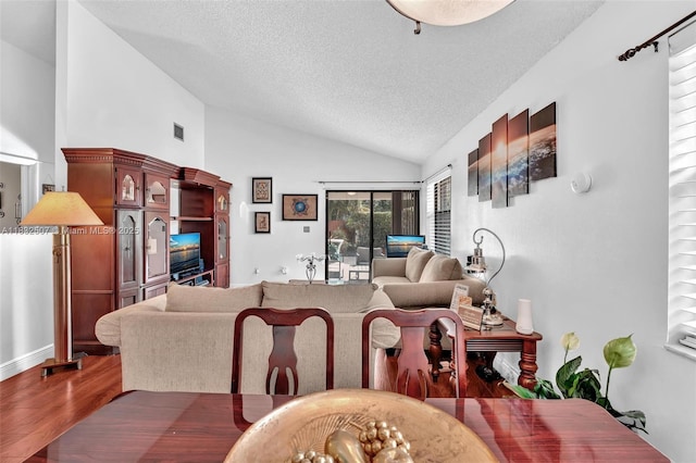 631 SW 113th Ave, Pembroke Pines, FL 33025 - dining area featuring vaulted ceiling, a textured ceiling, and wood finished floors