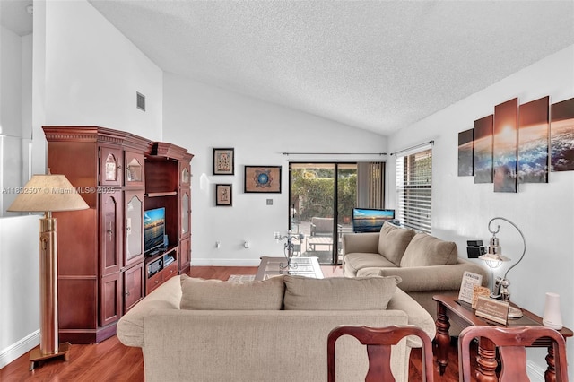 631 SW 113th Ave, Pembroke Pines, FL 33025 - living area with lofted ceiling, a textured ceiling, and light wood finished floors