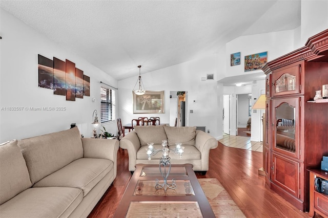 631 SW 113th Ave, Pembroke Pines, FL 33025 - living area with lofted ceiling, wood finished floors, and a textured ceiling