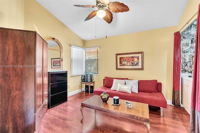 631 SW 113th Ave, Pembroke Pines, FL 33025 - living room with vaulted ceiling, ceiling fan, wood finished floors, and a textured ceiling