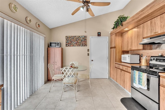 631 SW 113th Ave, Pembroke Pines, FL 33025 - kitchen with under cabinet range hood, appliances with stainless steel finishes, lofted ceiling, ceiling fan, and light tile patterned flooring
