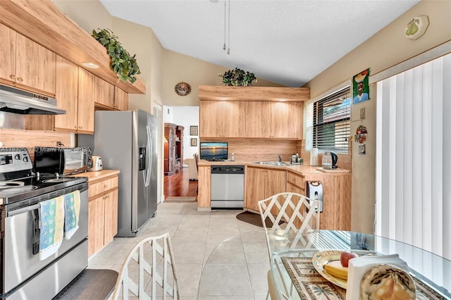 631 SW 113th Ave, Pembroke Pines, FL 33025 - kitchen with stainless steel appliances, under cabinet range hood, vaulted ceiling, light brown cabinets, and light tile patterned floors