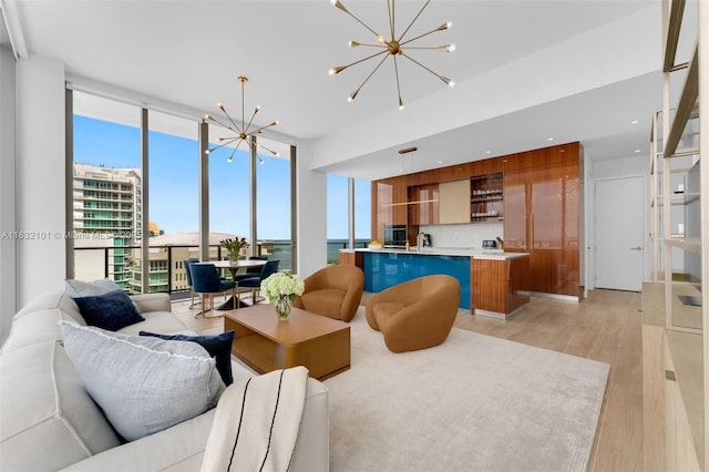 2655 S Bayshore Dr Unit 2012, Miami, FL 33133 - living area with a chandelier, floor to ceiling windows, and light wood-style floors