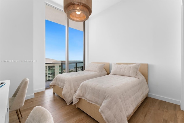 2655 S Bayshore Dr Unit 2012, Miami, FL 33133 - bedroom featuring floor to ceiling windows and wood finished floors