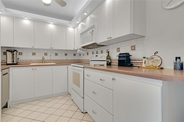 2500 NE 135th St Unit C711, North Miami, FL 33181 - kitchen with white appliances, tasteful backsplash, white cabinetry, recessed lighting, and light tile patterned flooring
