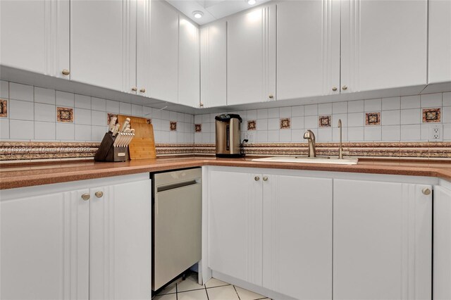 2500 NE 135th St Unit C711, North Miami, FL 33181 - kitchen featuring white cabinetry, backsplash, and light tile patterned floors