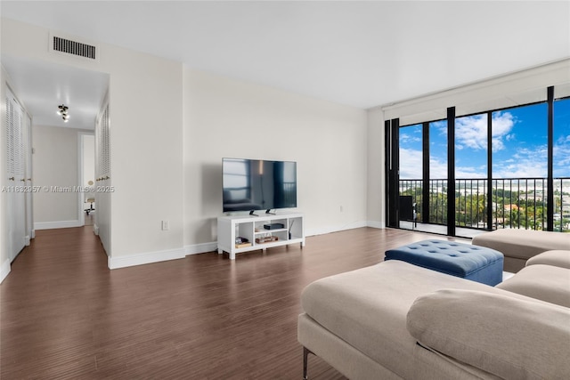2500 NE 135th St Unit C711, North Miami, FL 33181 - living area with floor to ceiling windows and dark wood-style flooring