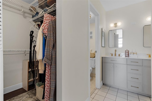 2500 NE 135th St Unit C711, North Miami, FL 33181 - full bathroom with double vanity, a walk in closet, and tile patterned floors