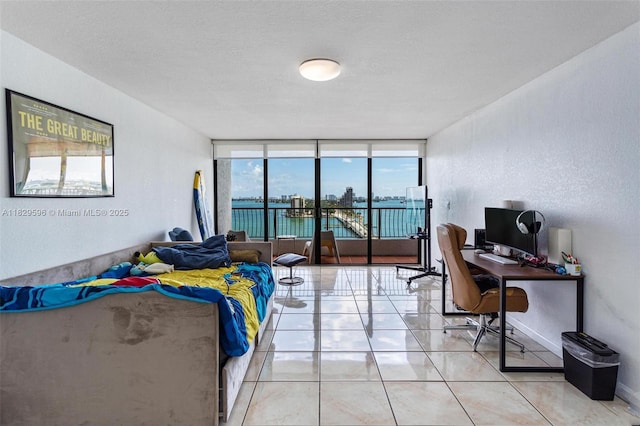 555 NE 15th St Unit 15B, Miami, FL 33132 - bedroom featuring access to exterior, a desk, and light tile patterned floors