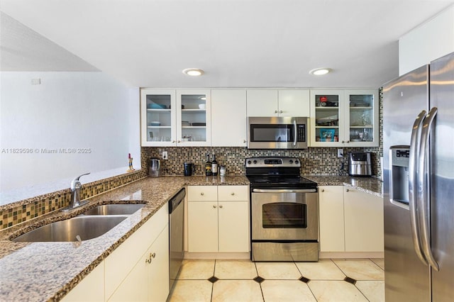 555 NE 15th St Unit 15B, Miami, FL 33132 - kitchen with appliances with stainless steel finishes, tasteful backsplash, dark stone countertops, recessed lighting, and light tile patterned flooring