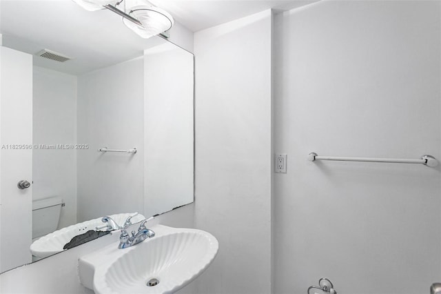 555 NE 15th St Unit 15B, Miami, FL 33132 - half bathroom with a sink and toilet