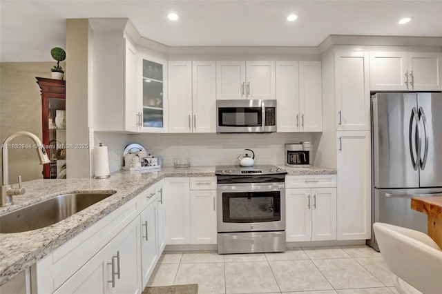 800 SW 125th Way Unit 405O, Pembroke Pines, FL 33027 - kitchen featuring stainless steel appliances, light tile patterned flooring, white cabinets, backsplash, and recessed lighting