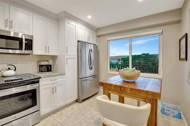 800 SW 125th Way Unit 405O, Pembroke Pines, FL 33027 - kitchen featuring stainless steel appliances, light tile patterned floors, tasteful backsplash, white cabinets, and recessed lighting