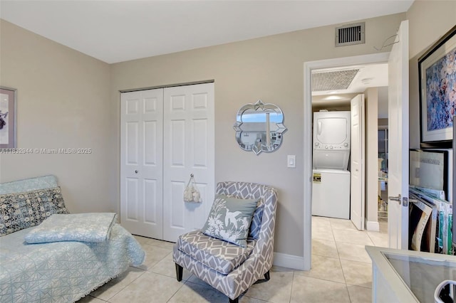 800 SW 125th Way Unit 405O, Pembroke Pines, FL 33027 - bedroom featuring stacked washing machine and dryer, light tile patterned flooring, and a closet
