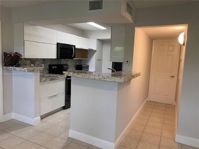 15661 SW 104th Ter Unit 3112, Miami, FL 33196 - kitchen with black appliances, light tile patterned floors, white cabinets, and decorative backsplash