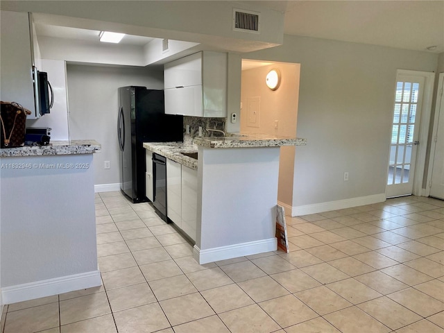 15661 SW 104th Ter Unit 3112, Miami, FL 33196 - kitchen featuring light tile patterned floors, black appliances, white cabinets, and light stone countertops
