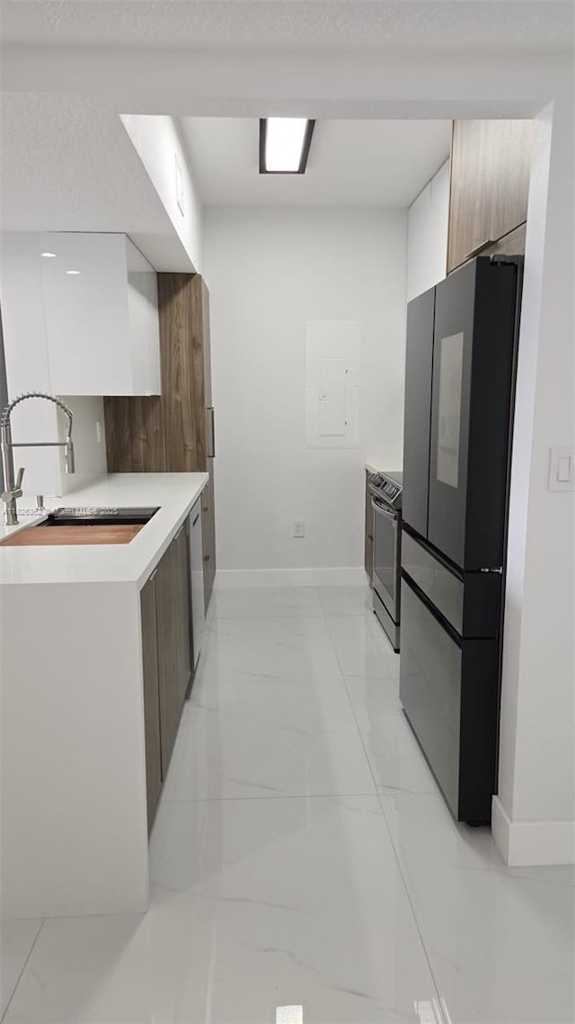 230 SW 117th Ter, Pembroke Pines, FL 33025 - kitchen with freestanding refrigerator, modern cabinets, electric stove, light marble finish floors, and light countertops