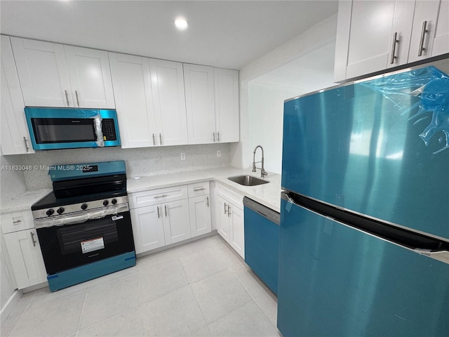 7915 Camino Real Unit N-302, Miami, FL 33143 - kitchen with appliances with stainless steel finishes, white cabinets, and light tile patterned floors