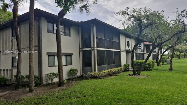 9459 W Mcnab Rd Unit 215, Tamarac, FL 33321 - view of side of home with stucco siding and a yard