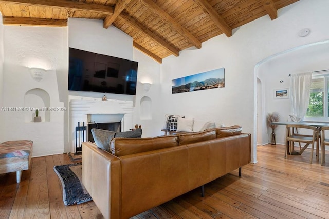 631 NE 87th St, Miami, FL 33138 - living room with a wooden ceiling with exposed beams, hardwood / wood-style floors, arched walkways, a fireplace, and high vaulted ceiling