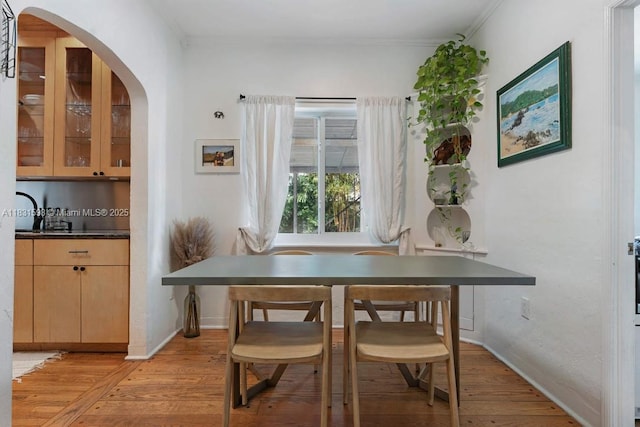 631 NE 87th St, Miami, FL 33138 - dining room with light wood-style floors, crown molding, and arched walkways