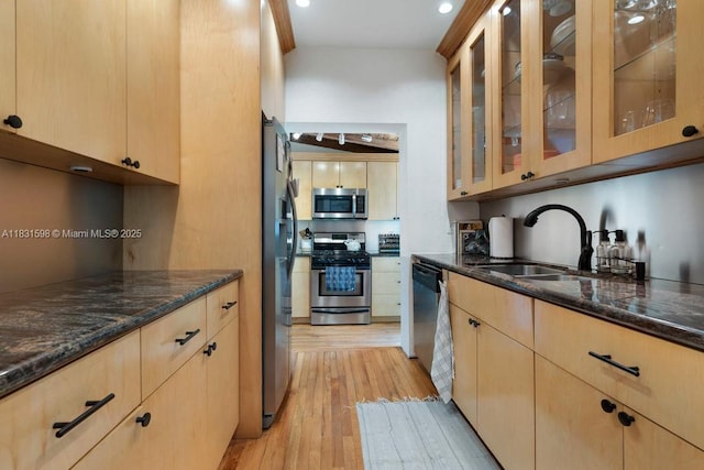 631 NE 87th St, Miami, FL 33138 - kitchen featuring appliances with stainless steel finishes, light brown cabinetry, dark stone countertops, light wood-type flooring, and recessed lighting
