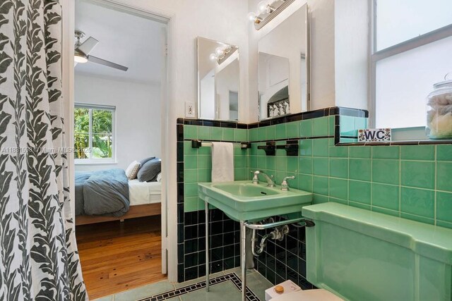 631 NE 87th St, Miami, FL 33138 - ensuite bathroom with tile walls and wainscoting