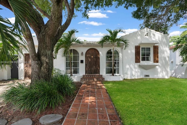 631 NE 87th St, Miami, FL 33138 - mediterranean / spanish house featuring crawl space, a front yard, and stucco siding