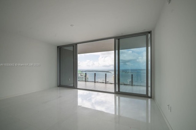 300 Biscayne Blvd Way Unit 4603, Miami, FL 33131 - tiled empty room featuring a wall of windows and a water view