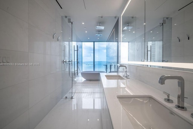 300 Biscayne Blvd Way Unit 4603, Miami, FL 33131 - bathroom with a stall shower, a freestanding tub, double vanity, and tile walls