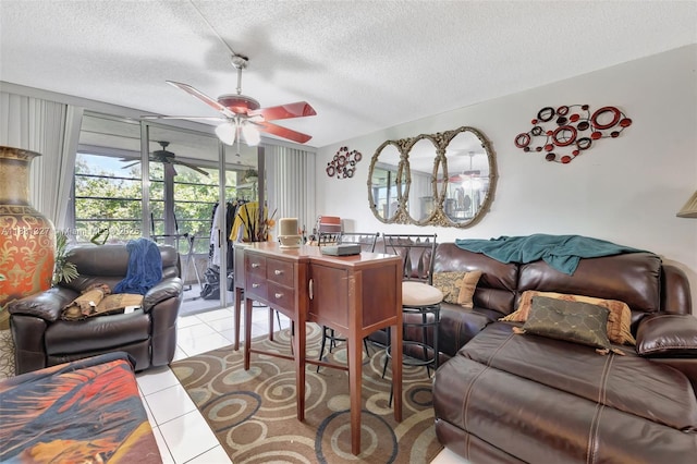 3070 NW 48th Ter Unit 415, Lauderdale Lakes, FL 33313 - living room with a ceiling fan, a textured ceiling, and tile patterned floors