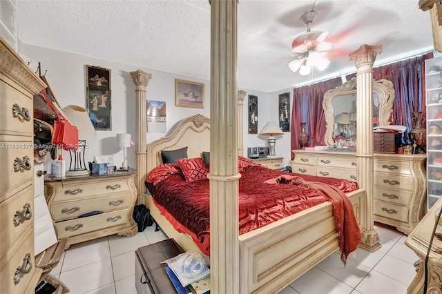 3070 NW 48th Ter Unit 415, Lauderdale Lakes, FL 33313 - bedroom featuring decorative columns, light tile patterned flooring, a textured ceiling, and ceiling fan