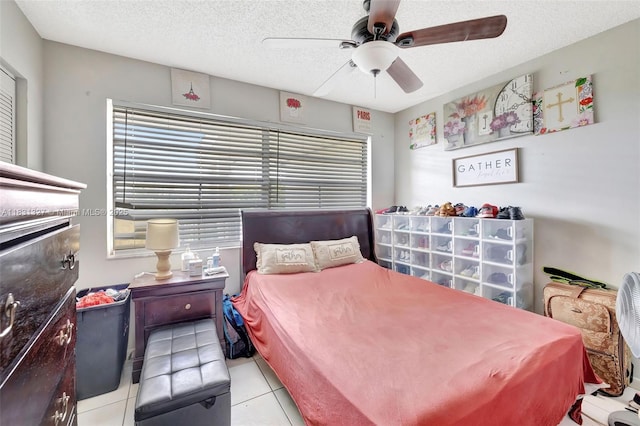 3070 NW 48th Ter Unit 415, Lauderdale Lakes, FL 33313 - tiled bedroom with a textured ceiling and a ceiling fan