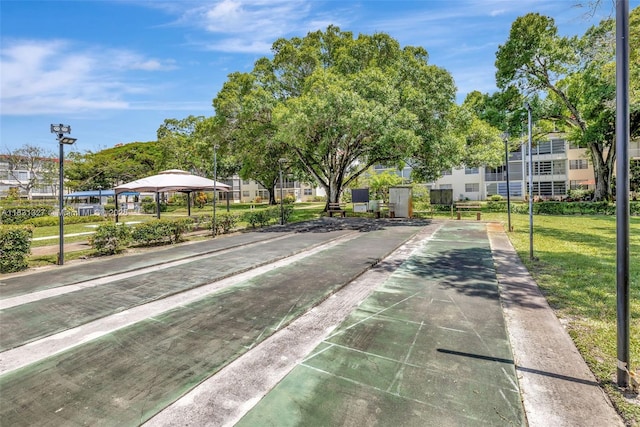 3070 NW 48th Ter Unit 415, Lauderdale Lakes, FL 33313 - view of community featuring shuffleboard, a yard, and a gazebo