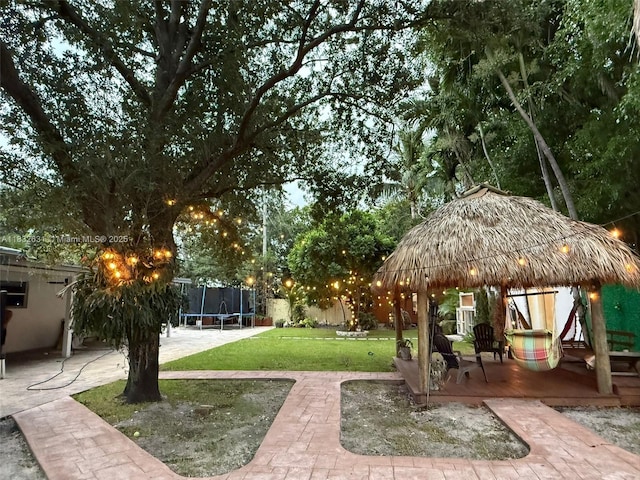 5838 Madison St, Hollywood, FL 33023 - view of property's community with a trampoline, a gazebo, a patio area, and a lawn