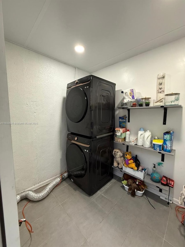 5838 Madison St, Hollywood, FL 33023 - laundry area featuring stacked washing machine and dryer and tile patterned floors