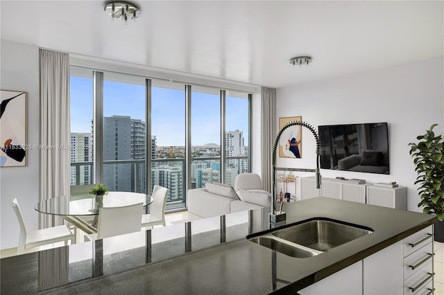 1111 SW 1st Ave Unit 2914-N, Miami, FL 33130 - kitchen with dark countertops, healthy amount of natural light, and white cabinets
