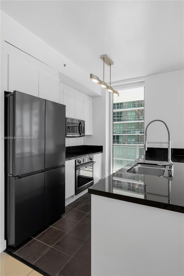 1111 SW 1st Ave Unit 2914-N, Miami, FL 33130 - kitchen featuring black appliances, dark countertops, white cabinets, and dark tile patterned flooring